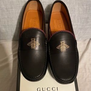 Brand New, Black Leather with The Signature Bee Symbol in Gold Located On Top